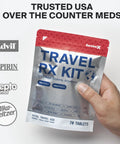 Front view of SurviveX Travel RX Kit pouch (silver body, red top) held by hand, 70 tablets.