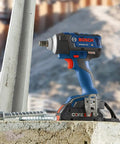 18V EC Brushless Half Inch Impact Wrench With Friction Ring And Through Hole Bare Tool Delivers Beast Power Up To 221 Ft-Lbs Torque For Lug Nuts, Lag Bolts And Concrete Anchors on concrete block