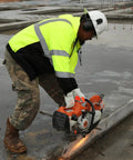 Worker cutting concrete wearing Hi Vis Lime Zipper Sweatshirt With Black Bottom Reflective Two Inch Tape Mesh Lined Hood, size XL