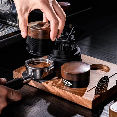 Barista using 53mm Espresso Tamper For Barista Pros Premium Calibrated Spring Loaded Stainless Steel on a Breville portafilter