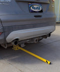 Tough As Nails Ground Mount Heavy Duty Steel Fold Down Bollard Padlock Secured Parking Lot Barrier Yellow Galvanized Safety Post under vehicle.