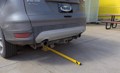 Tough As Nails Ground Mount Heavy Duty Steel Fold Down Bollard Padlock Secured Parking Lot Barrier Yellow Galvanized Safety Post under vehicle.
