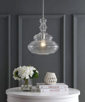 Chrome Modern LED Pendant Light for Kitchen Island and Hallways, clear glass shade, hanging above white table with decor.
