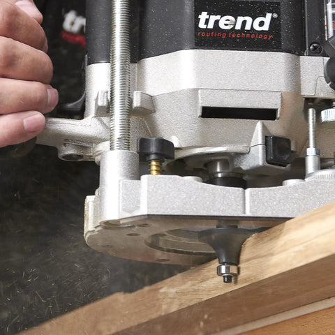 Badass 30 Piece Router Bit Starter Kit One Quarter Inch Shank Tungsten Carbide Tipped Bits Rock Solid Aluminum Case Included Universal Guided Cutters For Smooth Woodworking in use with a router on wood.