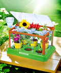 Awesome Kids Gardening Kit With Greenhouse And Terrarium showing flowers and plants in liftable roof greenhouse on wooden table.