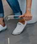 Person adjusting Clear Adult Squat Toilet Stool Elevates Your Feet For Healthy Bowel Elimination With A 35 Degree Angle, modern design.