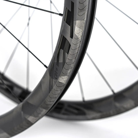Close-up of 700C Road Bike Carbon Wheelset with 40mm UD X Weave Aero Rims and Rim Brake Surface, showing weave pattern.
