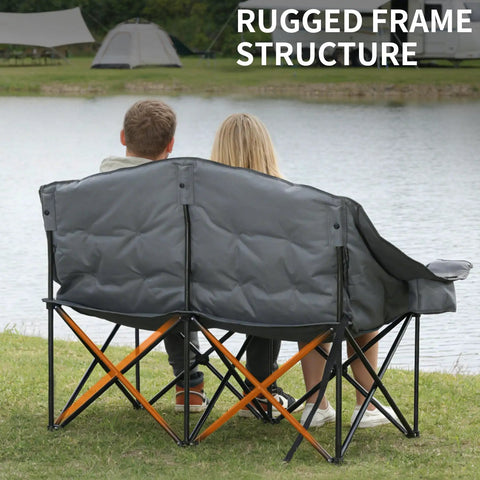 Couple sitting on Beast Mode Double Camping Chair With Cup Holders And Carry Bag, Heavy Duty Padded Folding 2 Person Outdoor Couch, Grey