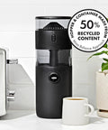 Compact Stainless Steel Conical Burr Electric Coffee Bean Grinder in black with coffee cup, measuring 11x4 inches, efficient for tight spaces.