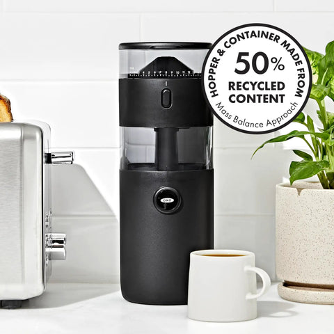 Compact Stainless Steel Conical Burr Electric Coffee Bean Grinder in black with coffee cup, measuring 11x4 inches, efficient for tight spaces.