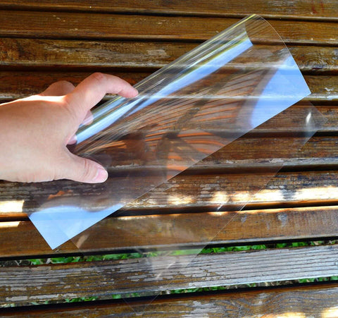 Side view of 12x12-inch clear PET stencil sheet, 10 mil, held by hand.