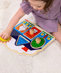 Child playing with First Shapes Jumbo Knob Puzzle For Toddlers With Wooden Peg Pieces, Kid Friendly Shape Matching Toy