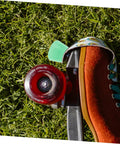 Quad skate with light green PU toe stop on grass. Toe Stop Replacement Pair For Quad Skates With PU Brake Pads No Fuss Install.