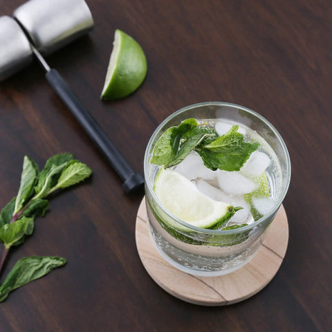 Glass with lime and mint on Desert Sandstone Coasters Set, All Natural Multicolor Stone With Unique Grain Patterns, Durable Round 4 Inch Drink Coasters
