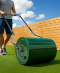 Man using Heavy Duty 16 Inch Steel Lawn Roller With U Shaped Handle Water Or Sand Filled Garden Roller on green lawn