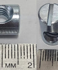 Cross Dowels and Barrel Nuts Bulk Pack Twenty Five One Quarter Twenty Thread Zinc Plated Steel 16 Millimeter By 10 Millimeter Off Centered CNC Slotted Hardware Connectors detailed view with ruler
