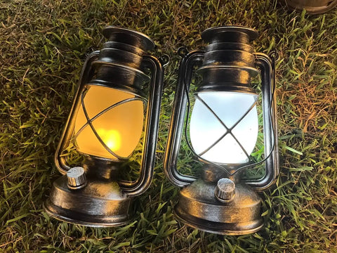 Bronze Outdoor LED Lantern With Vintage Flame Effect for garden and patio decor on grass showing realistic flicker and ambient glow.