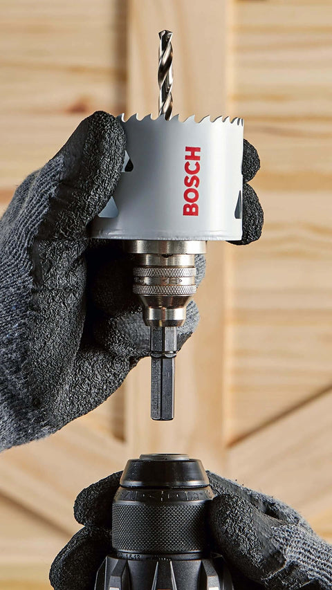 Close-up of Bosch HBT225 2-1/4 in bi-metal T-slot hole saw on arbor, held by gloved hand