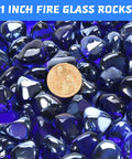 Close-up of cobalt blue fire glass beads with penny for scale, 1 inch in size, used in propane fire pits and fireplaces.