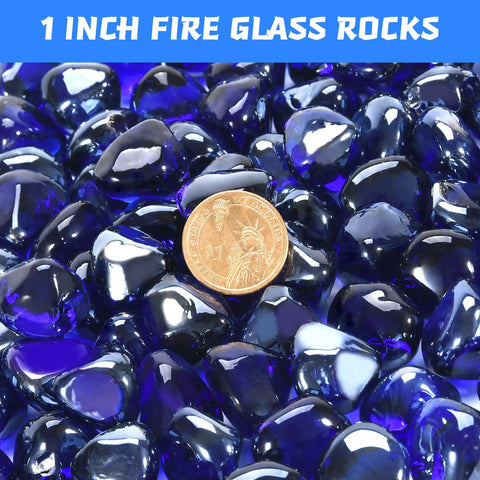 Close-up of cobalt blue fire glass beads with penny for scale, 1 inch in size, used in propane fire pits and fireplaces.