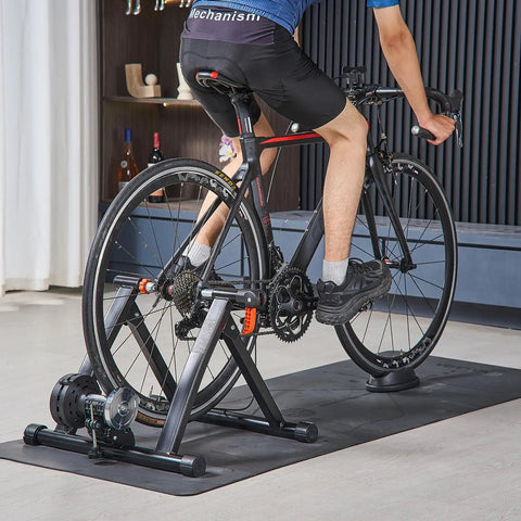 Cyclist using Foldable Magnetic Bike Trainer With Six Level Resistance Fits 26 To 29 Inch And 700C Road Wheels Indoor Cycling Stand