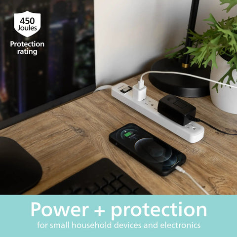 Six Outlet Surge Protector Power Strip With A 2 Ft Cord, 450 Joules Surge Protection on desk with devices plugged in