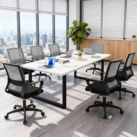 Office room with multiple ergonomic gaming chairs with lumbar support and armrests around a conference table, grey mesh back design.