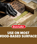 Applying The Real Deal Wood Filler Kit 30 Oz With Quick Set Hardener on damaged wood surface for repair.