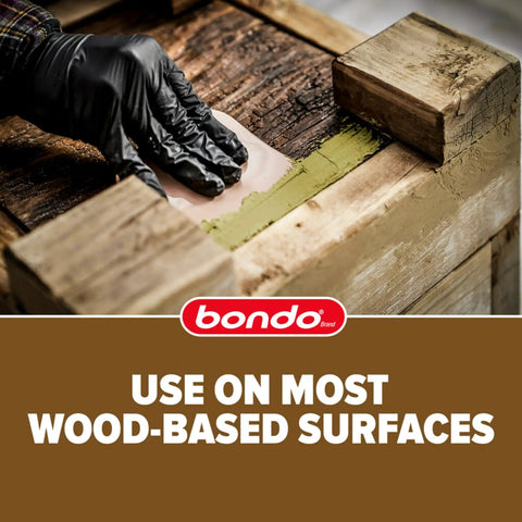 Applying The Real Deal Wood Filler Kit 30 Oz With Quick Set Hardener on damaged wood surface for repair.