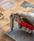 Dope Spring Plunger Tool For 0.158 In Steel Drum Fasteners with ergonomic grip in use on metal surface with metal components visible.
