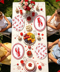 Rad Lobster Themed Oval Paper Plates 12 By 10 Inch 50 Pack Disposable Seafood Boil Dishes arranged on a festive outdoor dining table.