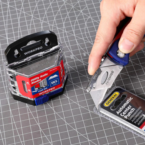 50 Pack Utility Knife Blades With Dispenser, Razor Sharp SK5 Steel Refills being used to cut packaging on work surface.