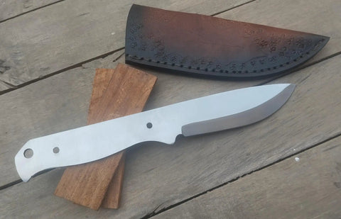 Nine Inch Stainless Outdoor Hunter Knife Kit With No Frills Blank Blade, rosewood scales and cowhide leather sheath on wood surface.