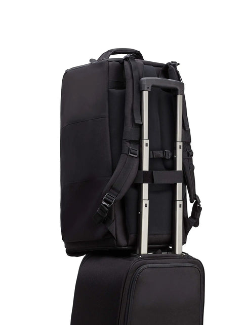 Cineluxe Backpack 24 for DSLR and Mirrorless Cameras with Lenses Black 637-512 attached to rolling luggage handle.