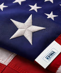 Close-up of Premium 3X5 Outdoor American Flag Made in USA With Embroidered Stars And Sewn Stripes, Made in USA tag visible.