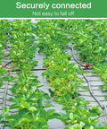 Durable 26 Piece Irrigation Fittings Kit For One Half Inch Tubing With Eight Couplings Six Tees Six Elbows Six End Cap Plugs Barbed Connectors For Drip And Sprinkler Systems Great Value For DIY Lawn And Garden Watering in action with green plants.