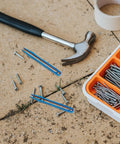 Titanium Alloy Tweezers Compact Machining Clamp Mini Travel Tool on pavement with screws and hammer visible