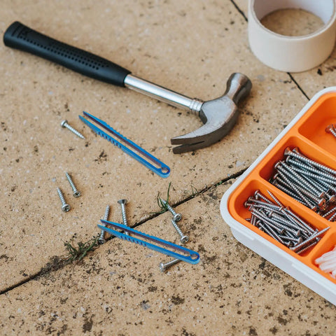 Titanium Alloy Tweezers Compact Machining Clamp Mini Travel Tool on pavement with screws and hammer visible