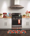 Modern kitchen setting with a stove illuminated by Reveal HD Appliance Light Bulb 40 Watt, 320 Lumens, highlighting oven and decor.