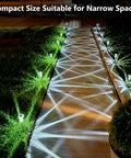 Solar LED Outdoor Stake Lights Pack Of 10 illuminating a pathway with cool white light at night