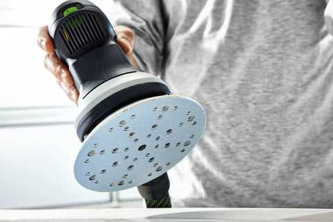 Person using ETS 150 Soft Sanding Pad For Heavy Duty Universal Use With High Temperature Durability StickFix Quick Change System