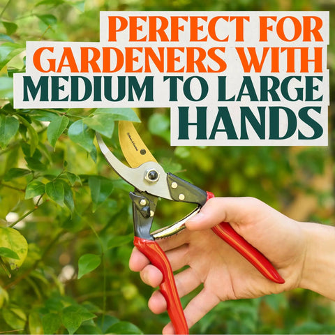 Person using Pro Grade 8.75 Inch Titanium Bypass Pruning Shears For Gardening to trim green branches, showing ergonomic grip.
