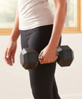 20 Pound Hex Dumbbell With Rubber Encased Cast Iron Core And Non Slip Contoured Handle For Home Gym Strength Training, being held by a person.