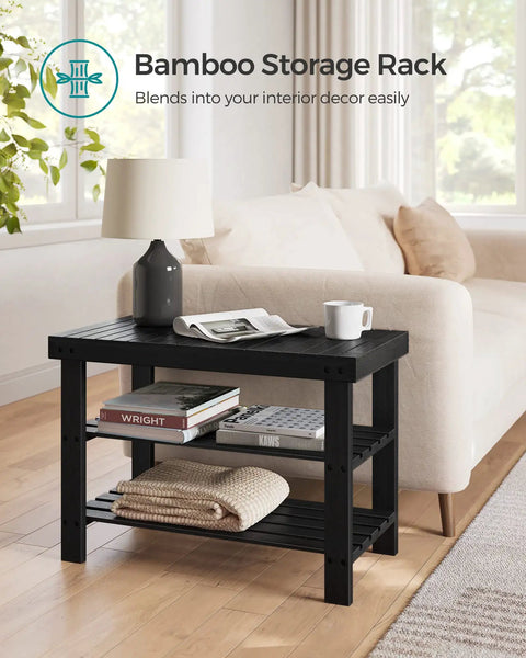 Sturdy Bamboo Shoe Bench With 3 Tier Storage For Entryway Or Bedroom Holds Up To 286 Lb And Keeps Shoes Neatly Tucked On Wide Shelves With A Top Panel For Bags Or Essentials Ink Black in a living room setting