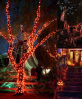 Two Pack Solar Christmas String Lights With Remote And Timer wrapped around trees and patio, Halloween decorations visible