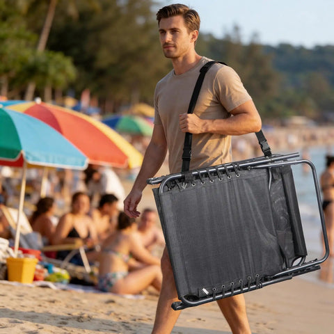 Man carrying Face Hole Tanning Loungers Set Of 2 Folding Outdoor Lounge Chairs with Five Position Recline at a beach.