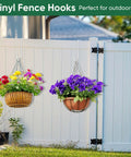 Six Pack 6 Inch Vinyl Fence Hooks White Powder Coated Steel Hangers holding planters on a white fence in an outdoor garden
