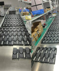 Many 1212P-2501 motor speed controllers on a factory assembly line, black rectangular modules.