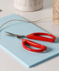 Unlimited Kitchen Scissors All Purpose Kitchen Shears With Comfortable Red Handles, Heavy Duty Stainless Steel Blades For Kitchen Tasks, Craft Cutting, Food Prep And More. Red-handled stainless steel scissors on a cutting mat