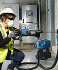 Worker using Two Cutter Head Three Quarter Inch By Twenty Four Inch SDS Plus Bulldog Rotary Hammer Bit in concrete drilling
